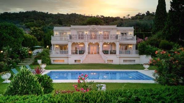 Stunning luxury villa with swimming pool at sunset